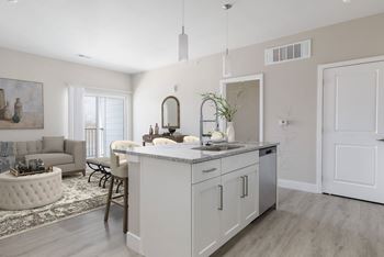 A modern kitchen with a large island and a dining area.